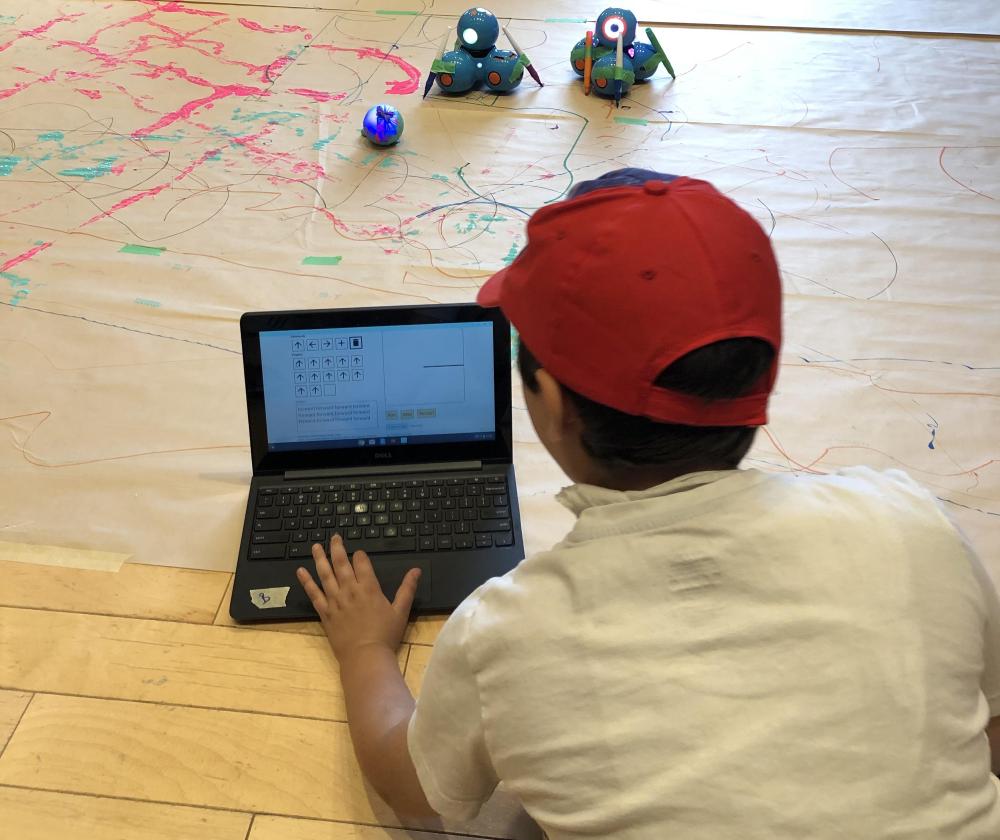 Camper coding sequences to create art with markers, paint and the robots, Dash and Sphero.